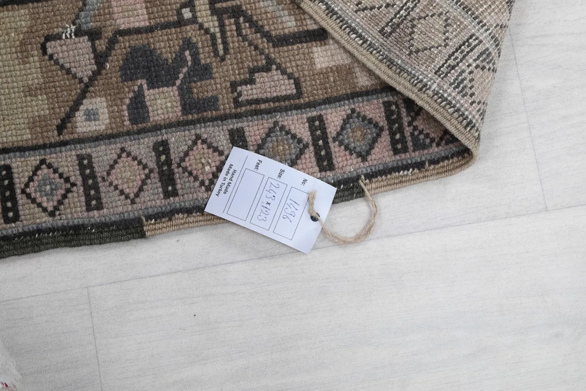 Corner of the rug with a product tag, indicating its origin and unique item number