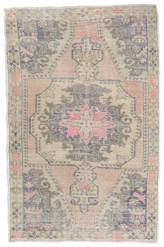 Full overhead view of the vintage Anatolian rug with rose, tan, and navy colors