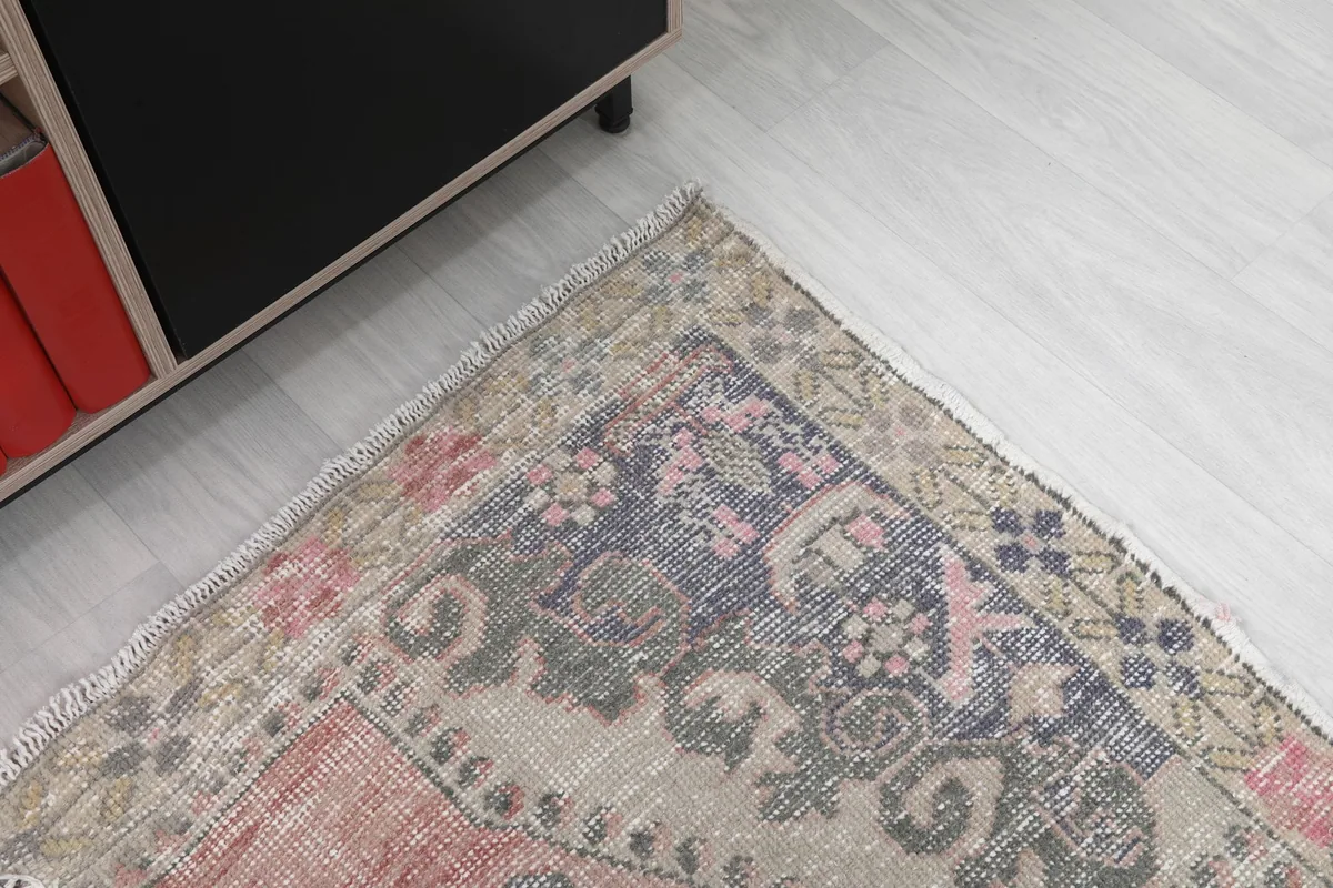 Corner detail of the rug's design and color variations near a piece of furniture