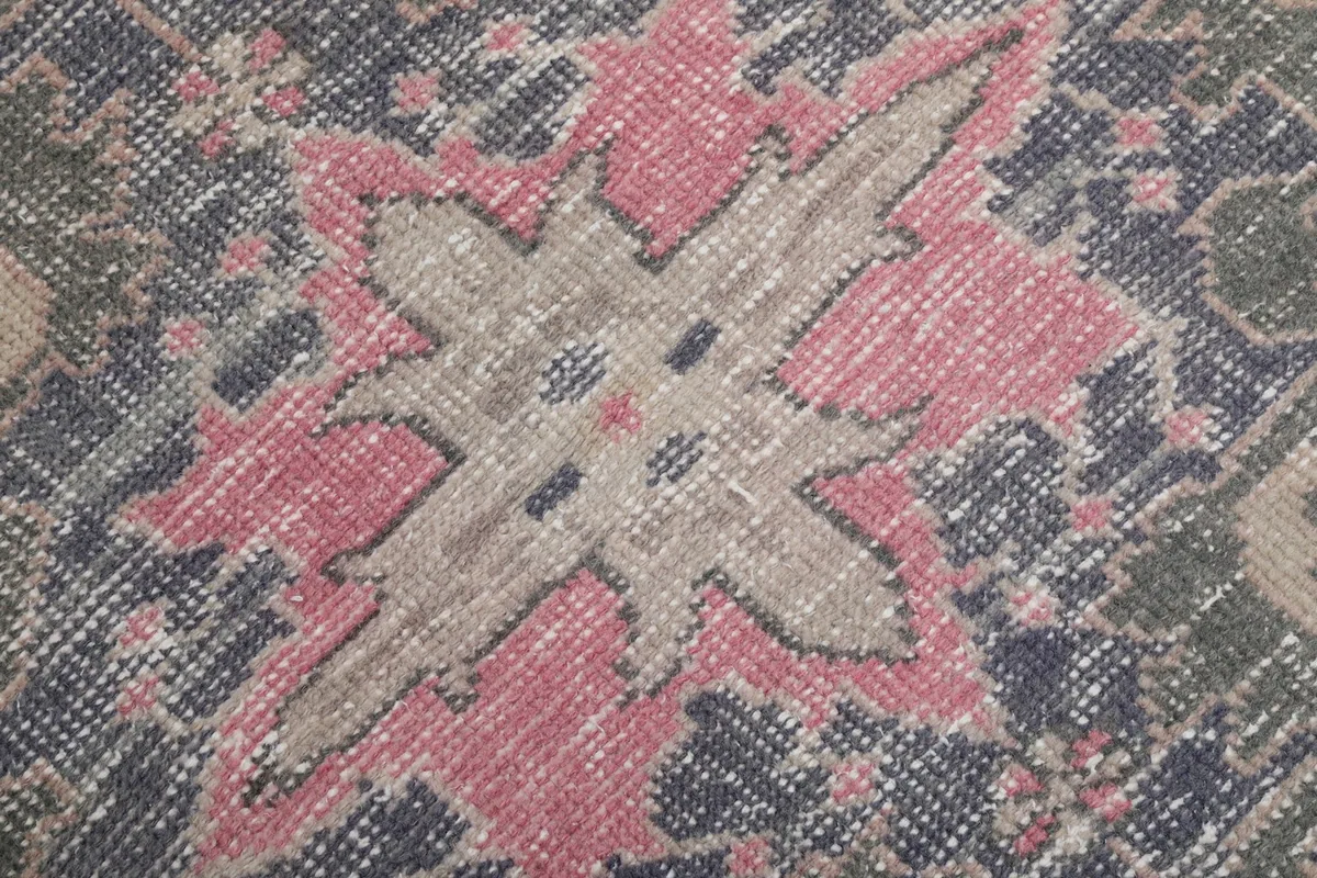Detailed close-up of the low wool pile and hand-knotted texture of the rug