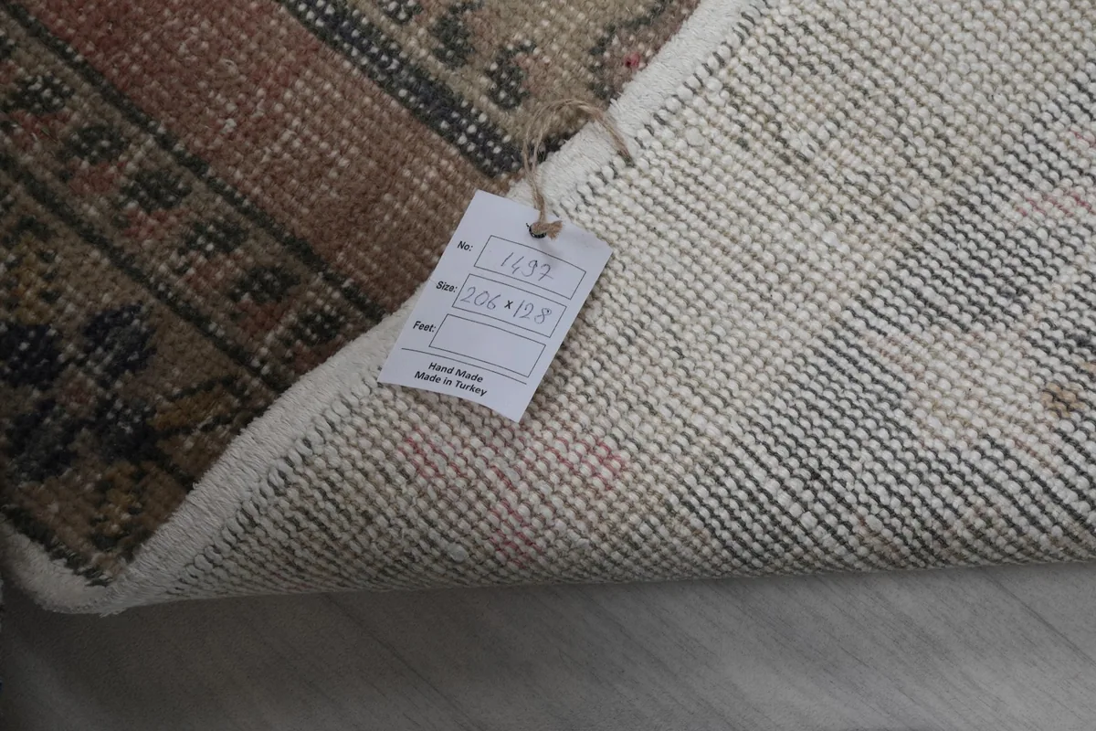 The rug's back side with a product tag showing dimensions and origin information