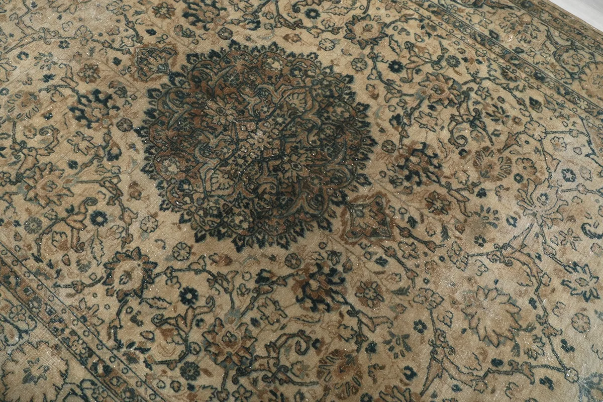 Close-up of the central blue medallion with intricate floral designs and subtle color variations