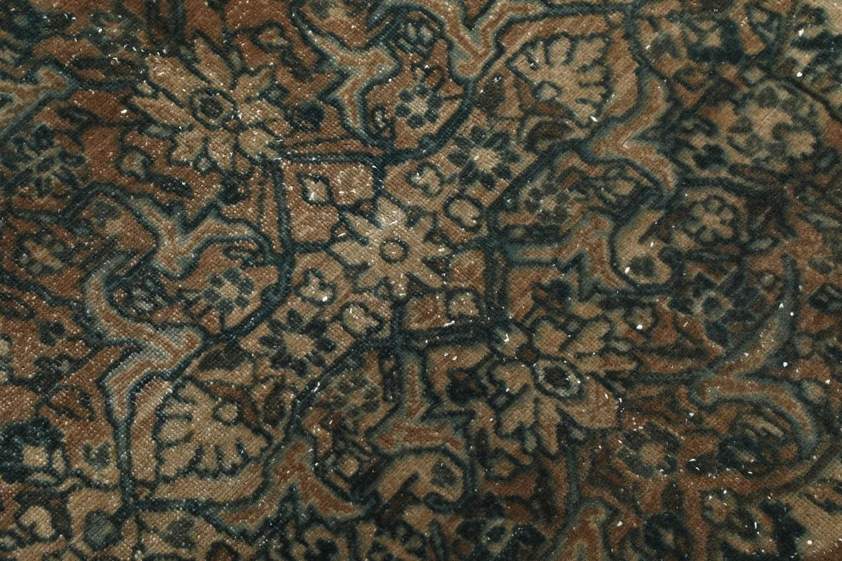 Macro close-up of the hand-knotted wool pile, showing individual knots and texture of the rug