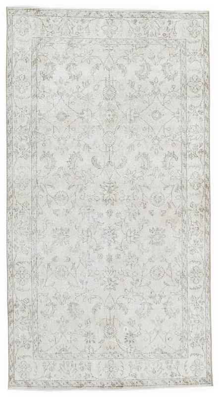 Full top view of the ivory floral vintage Anatolian rug on a white background