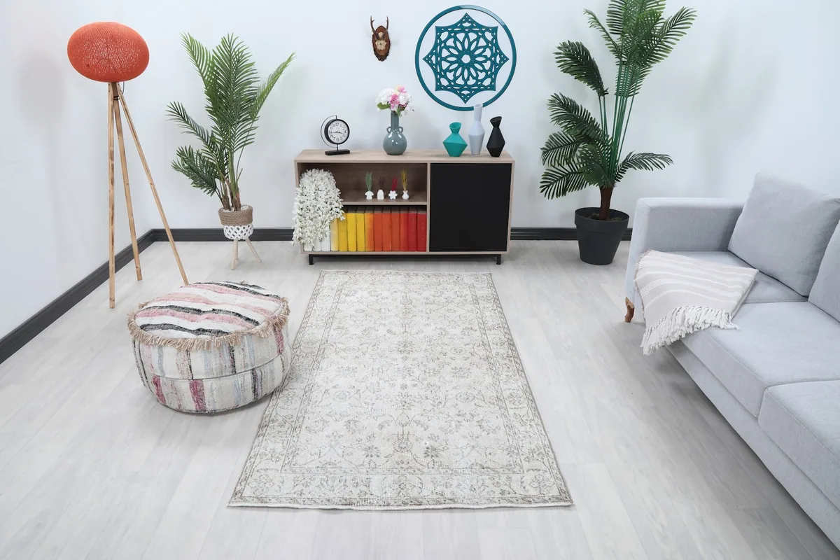 Ivory floral vintage rug in a modern living room setting with a gray sofa and plants
