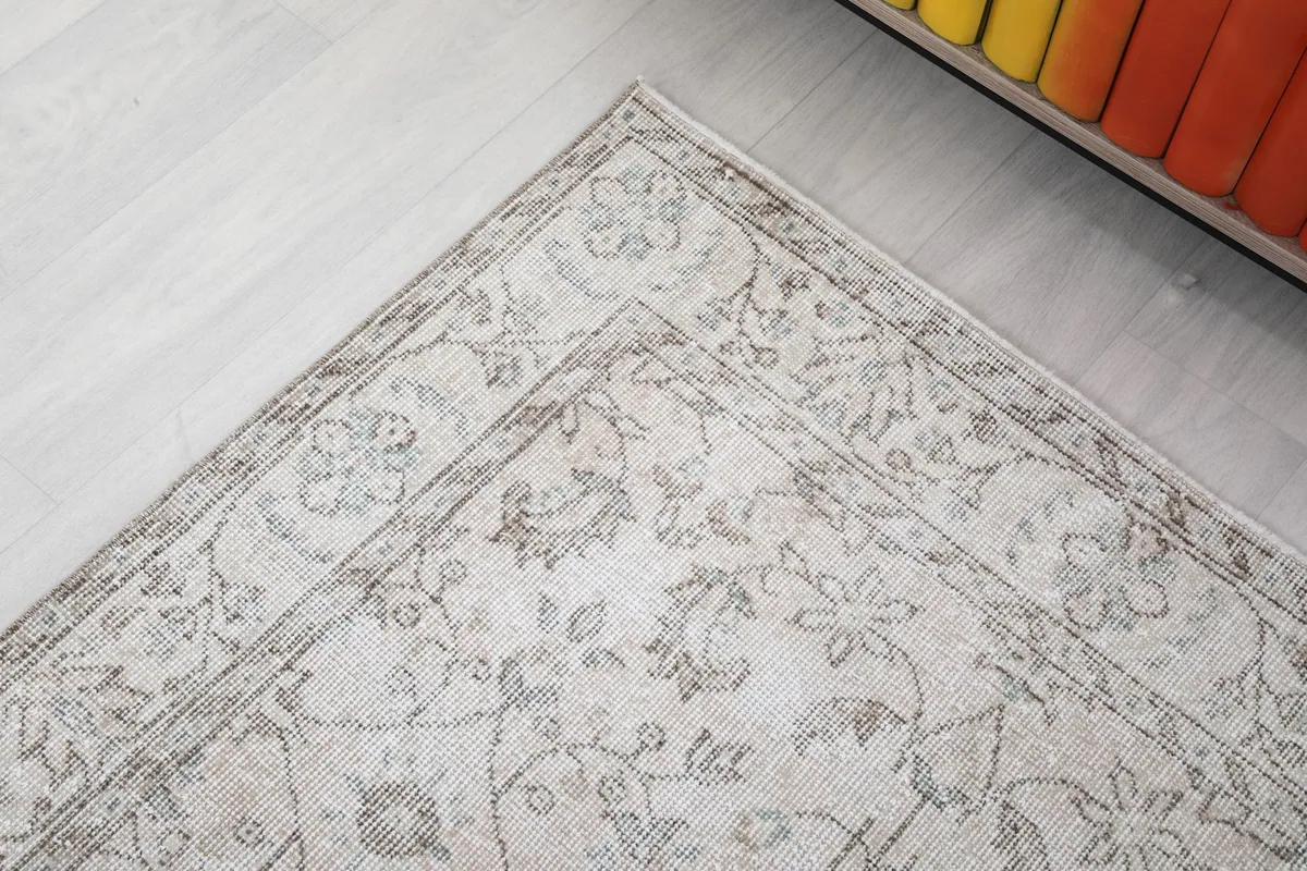 Corner detail of the rug showing the intricate floral and geometric border designs