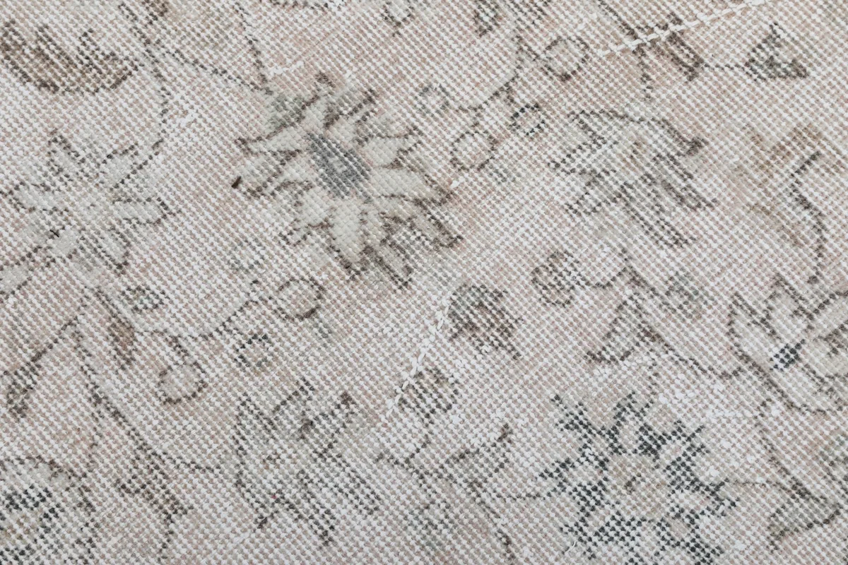 Macro shot of the low wool pile and hand-knotted texture of the vintage Anatolian rug