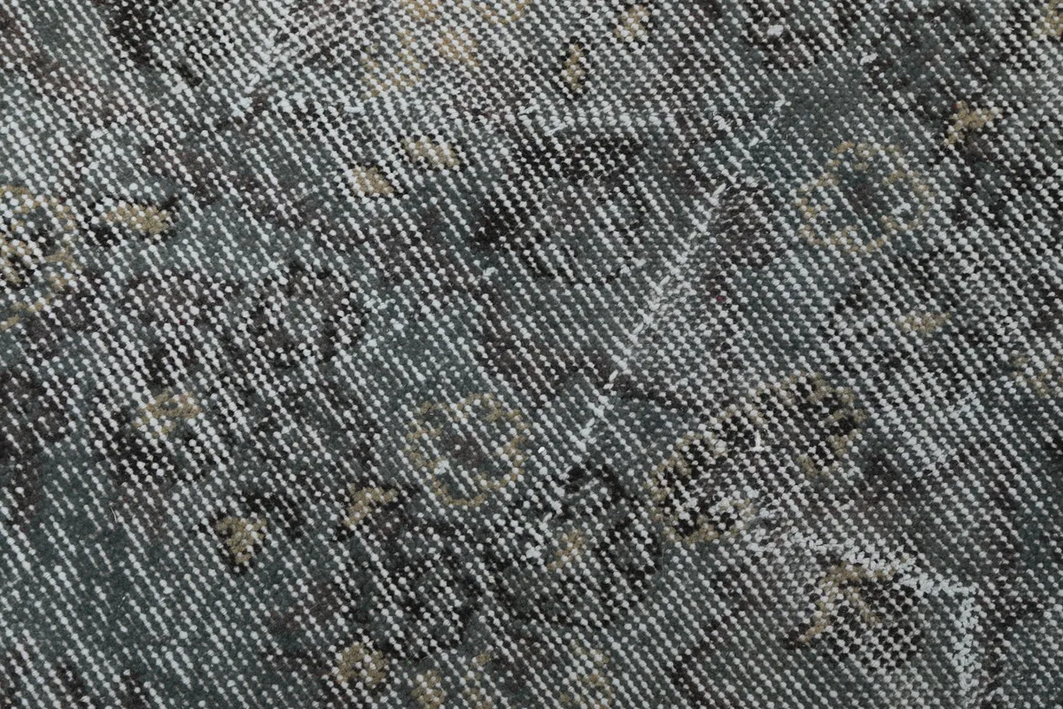 Extreme close-up of the low pile, highlighting the individual wool knots and subtle color shifts