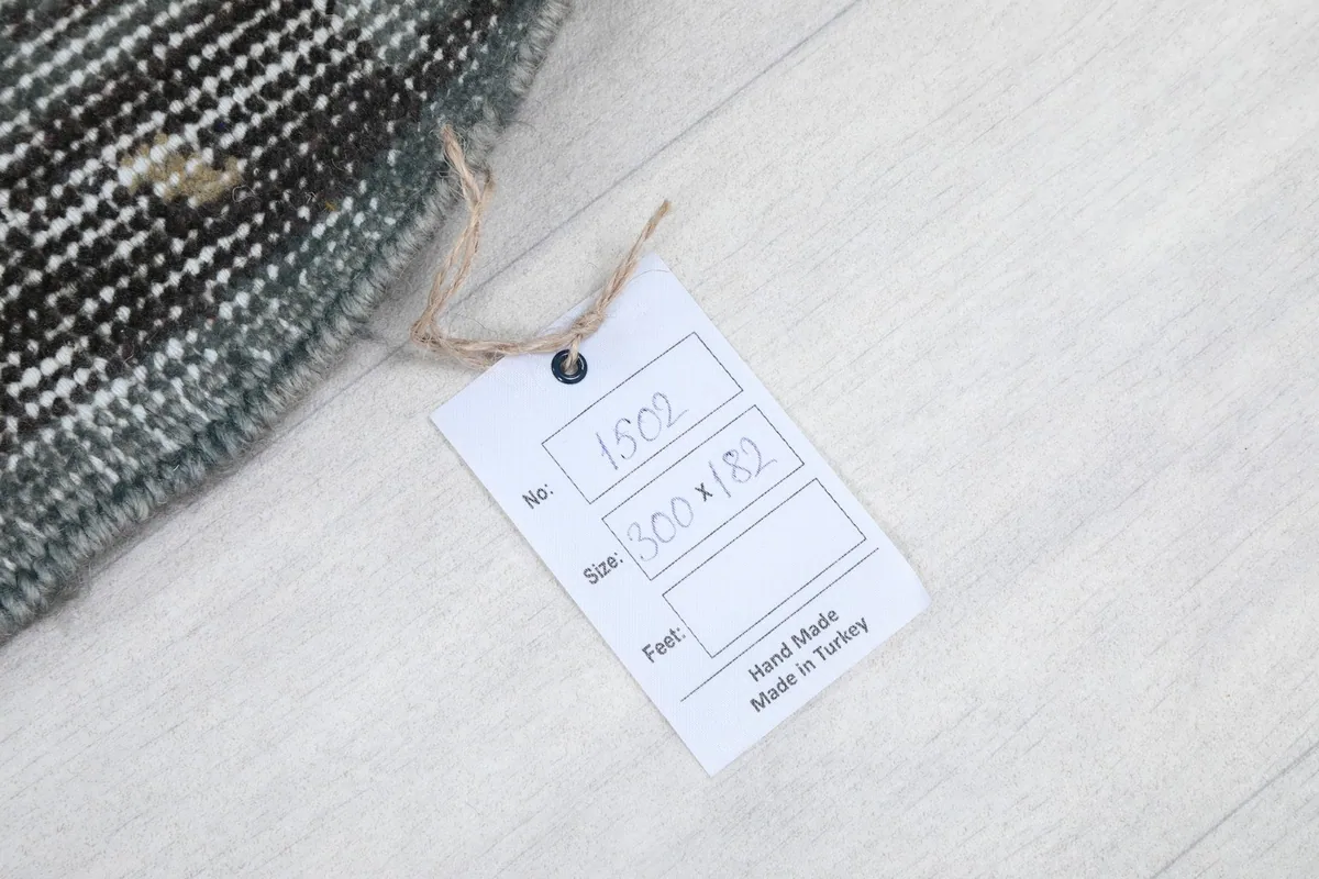 Product tag indicating the rug's size in centimeters and its origin as handmade in Turkey
