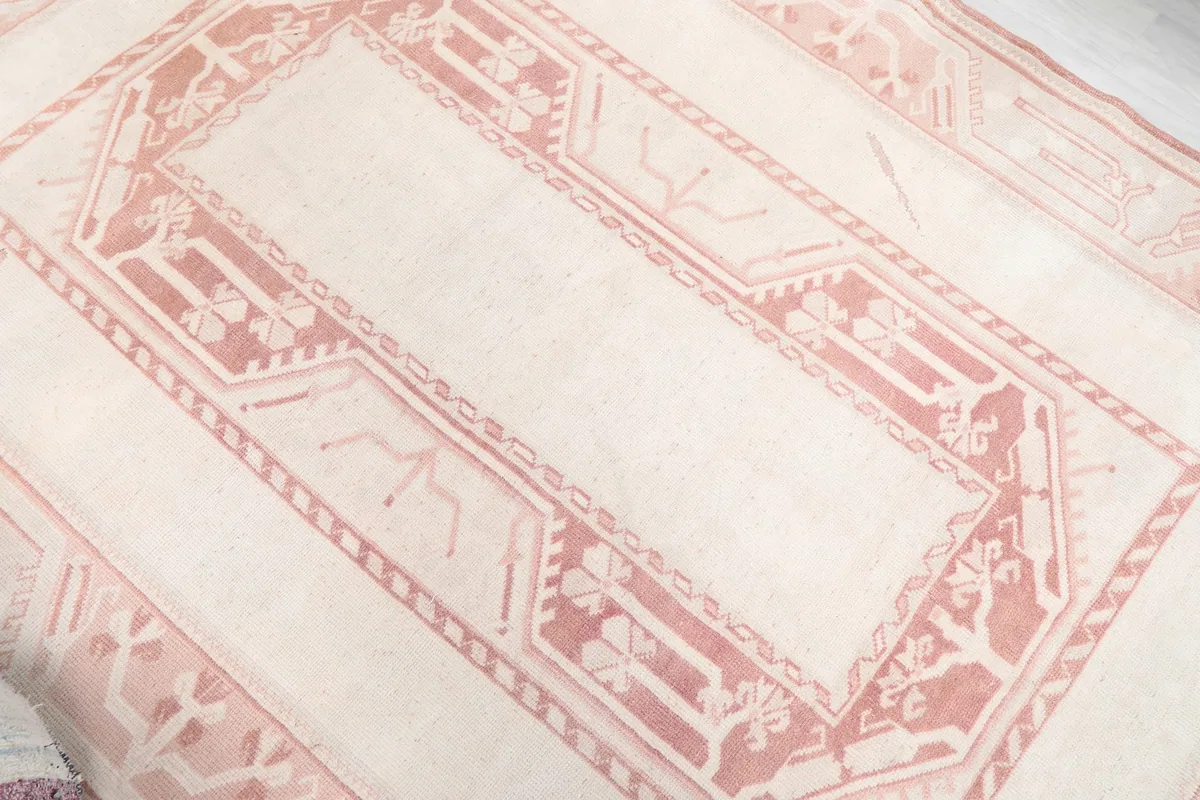 Angled shot highlighting the central ivory field and the surrounding rose patterns