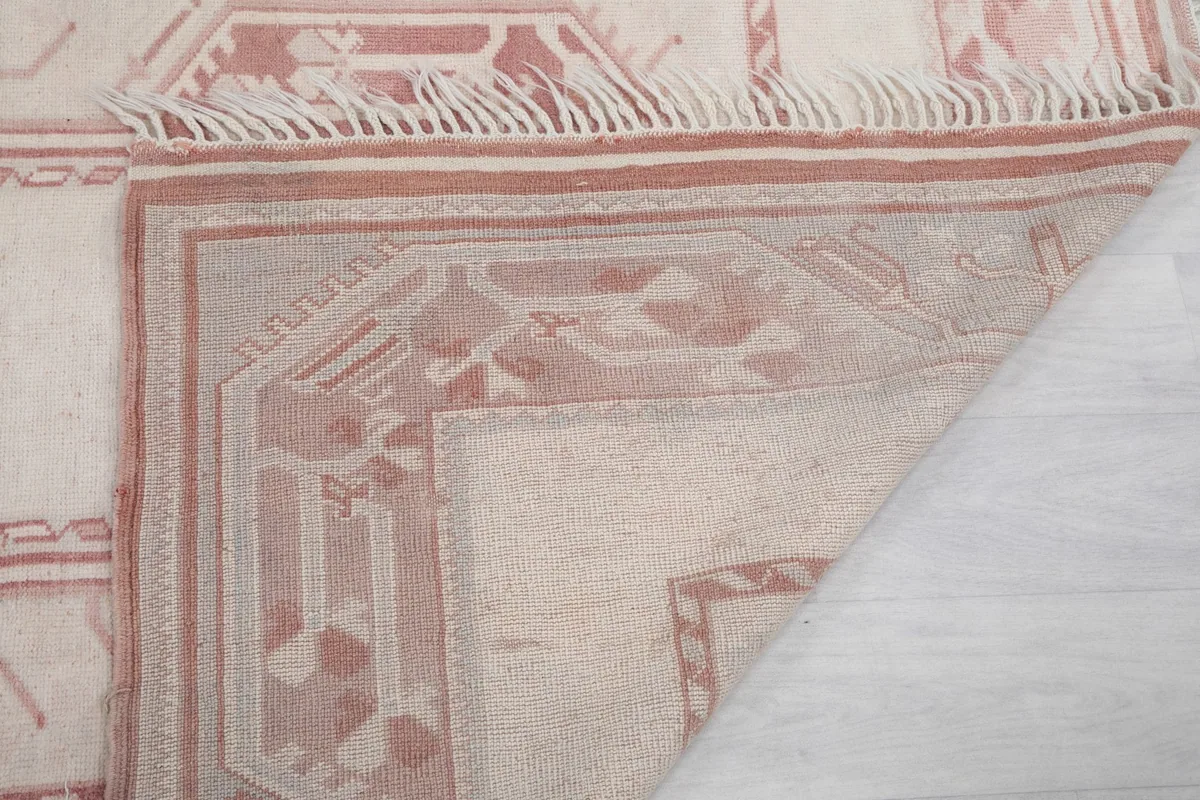 Close-up of the underside of the rug, showing the knotting and fringe