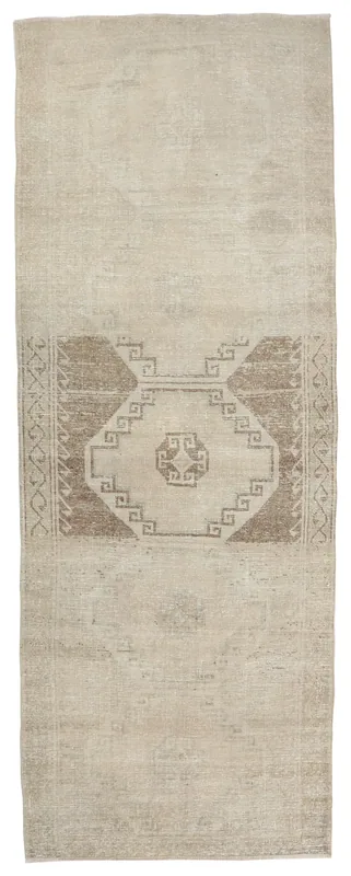 Full top view of the 3'10" x 10'8" beige and brown vintage Anatolian runner rug