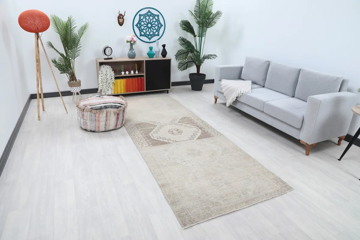 Overhead view of the beige runner rug in a room, showing its full length and placement
