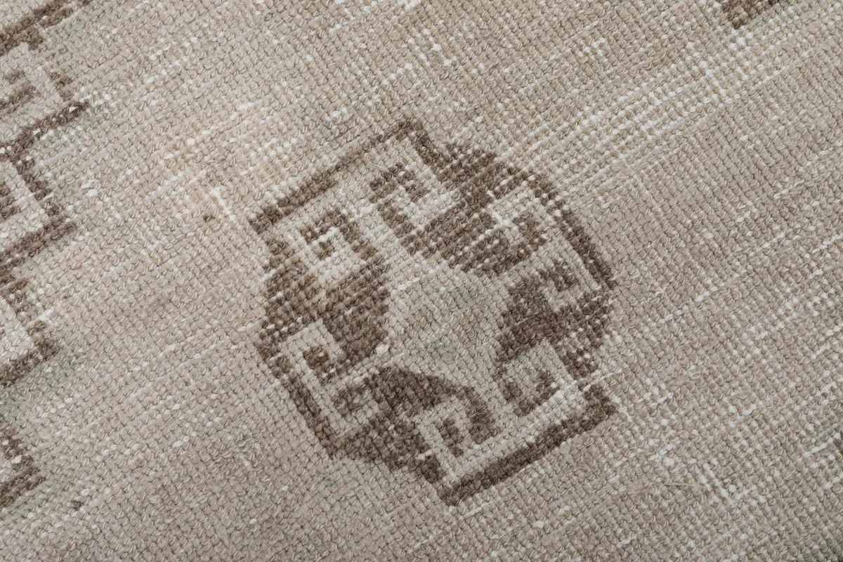 Intricate detail of the central motif within the brown medallion on the rug