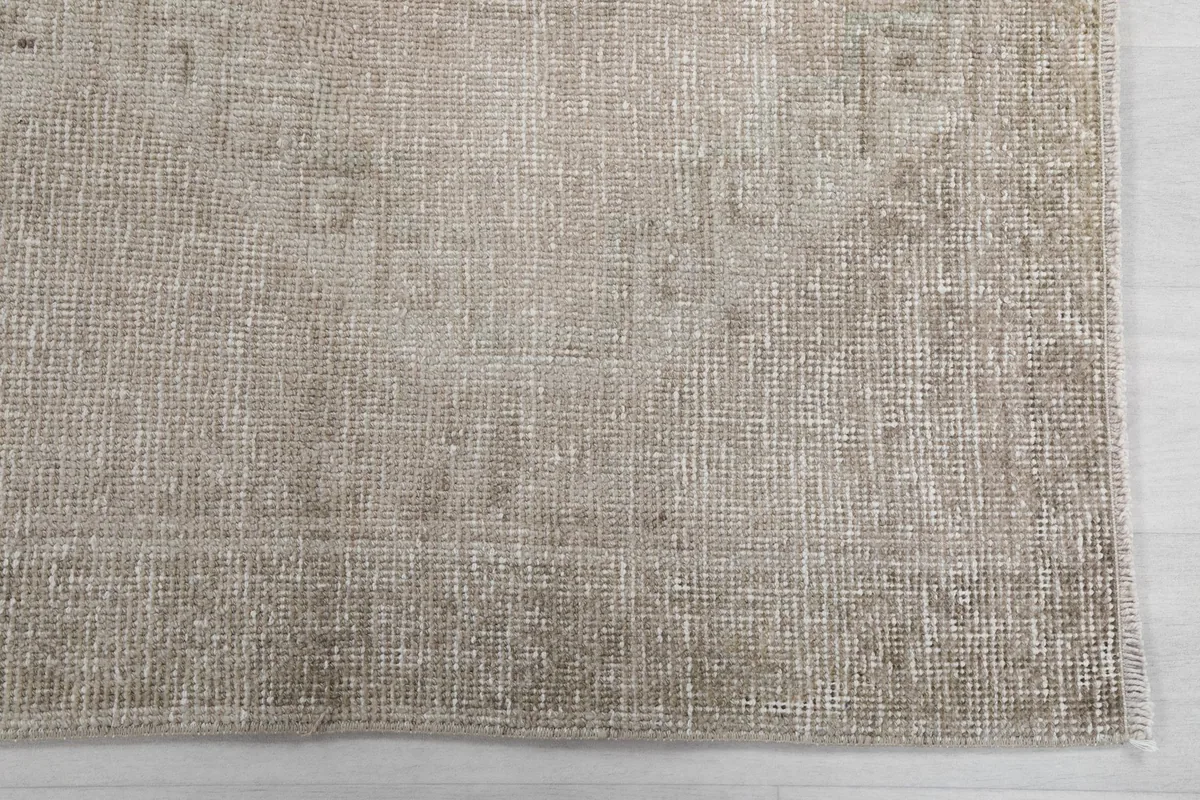 Detailed view of the low wool pile and texture of the vintage beige runner rug