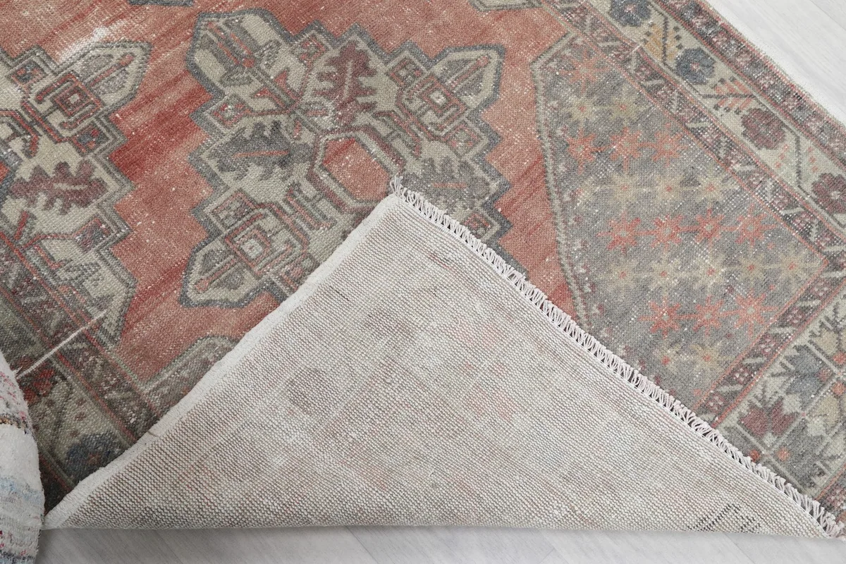 Underside of the hand-knotted wool rug, revealing the cotton foundation and construction.