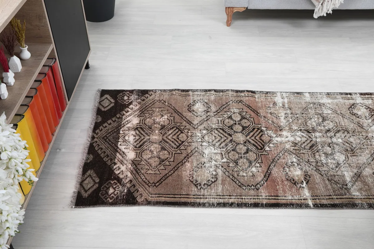 Angled view of the runner rug on the floor, showing its length and pattern flow