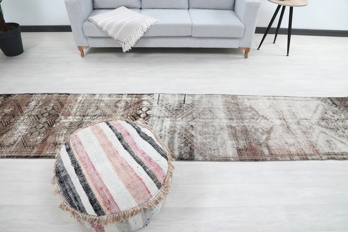 View of the runner rug in a room from the opposite end, showing its full length with furniture