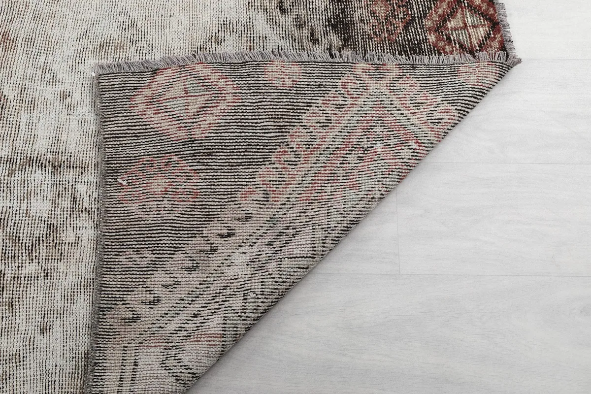 Another view of the rug's back, revealing the tight knotting and wool pile on cotton foundation