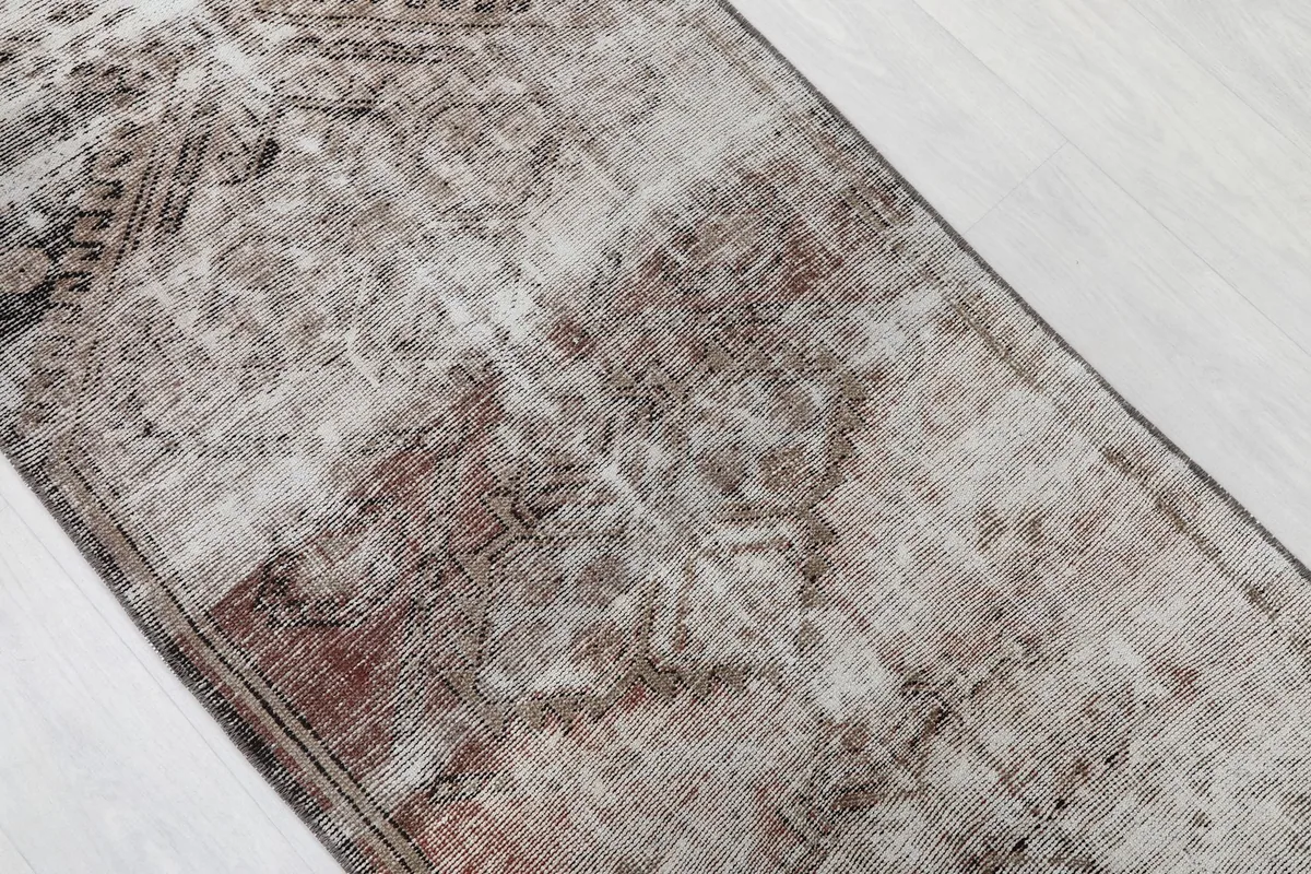 Overhead view of a section of the runner, showing faded gray, brown, and rust colors