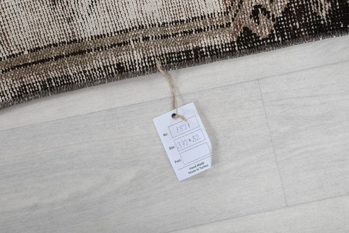 Product tag attached to the rug, displaying its dimensions and origin details