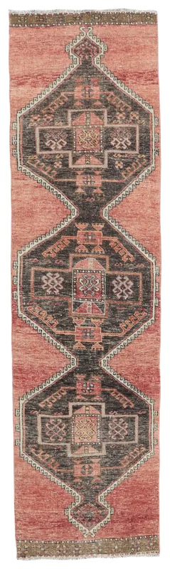 Full overhead view of the rust and charcoal geometric Anatolian runner rug on a white background.