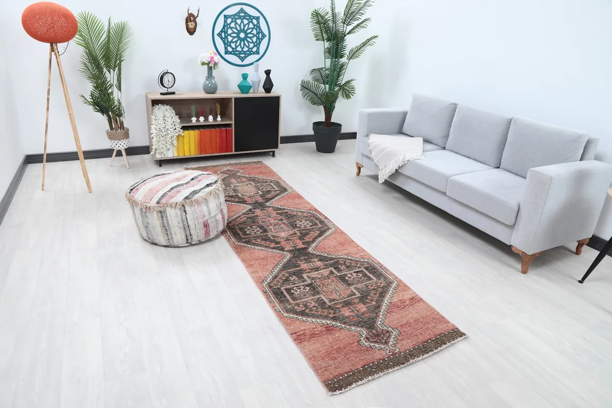 Angle view of the rust runner rug in a modern living space, showing its length and design.