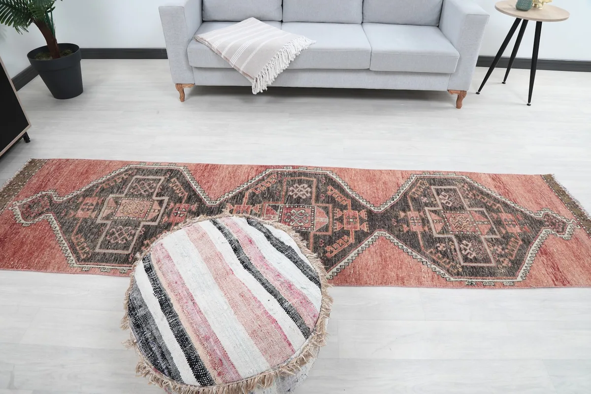 Full room view with the runner rug, sofa, and ottoman, showcasing its placement and scale.