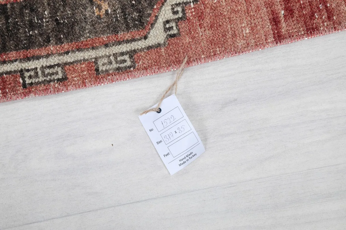 Close-up of the product tag attached to the rug, showing details and origin.