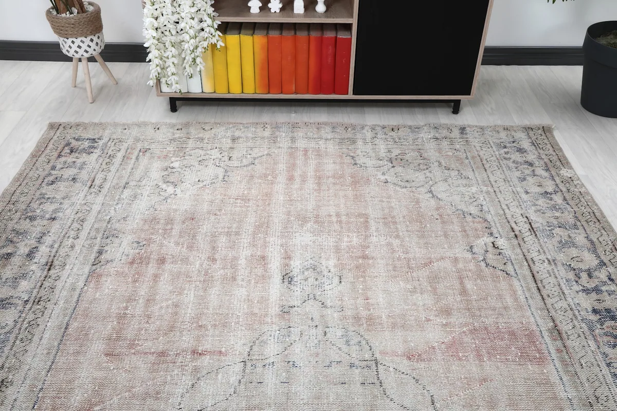 View from above showing the full rug in a room, highlighting its faded colors