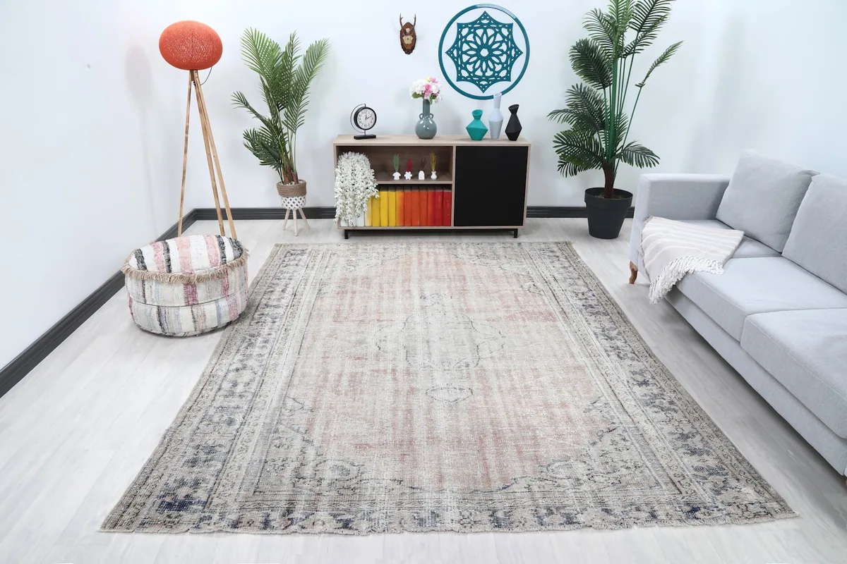 Vintage Anatolian rug in a living room setting with a sofa and decor
