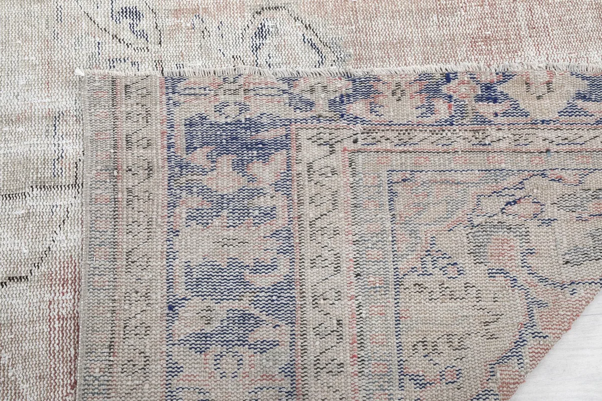 Extreme close-up of the border, showing the texture and color variations of the wool pile