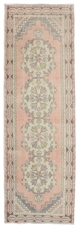 Full overhead view of the vintage rose and ivory Anatolian runner rug