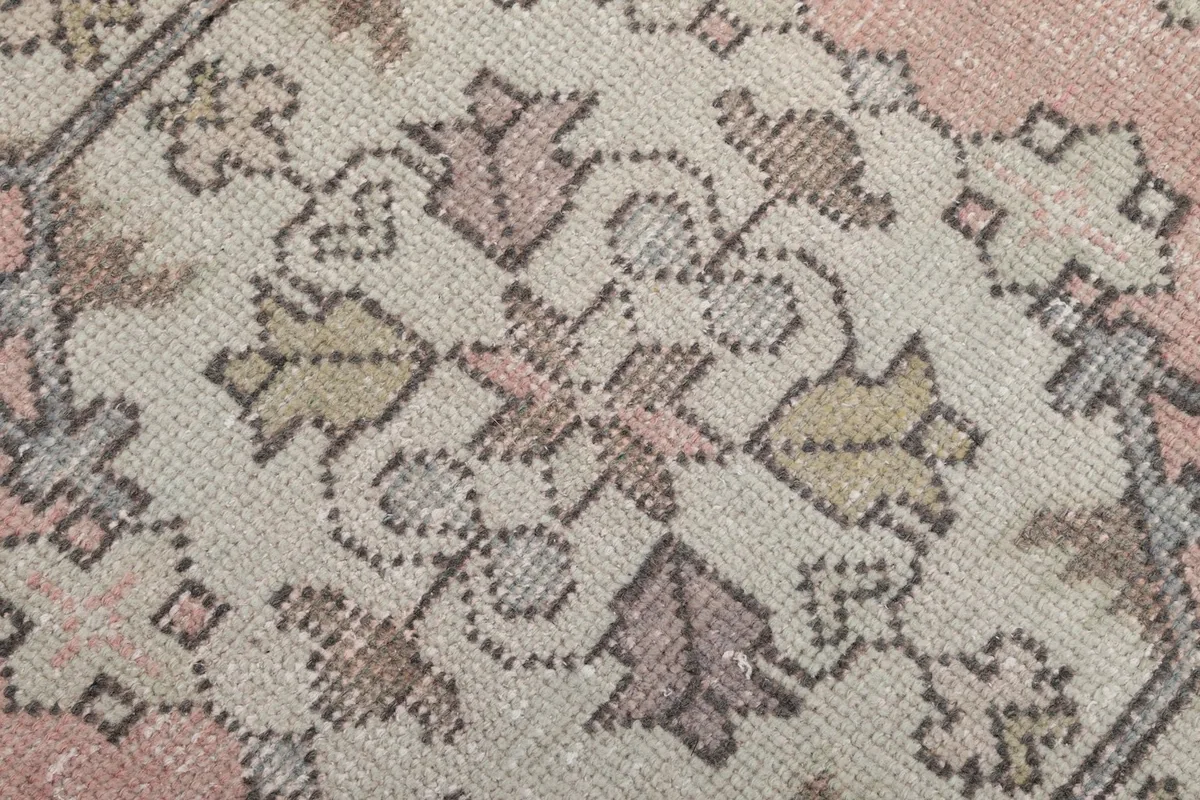Texture and low pile of the hand-knotted wool rug, showing individual knots and color variations