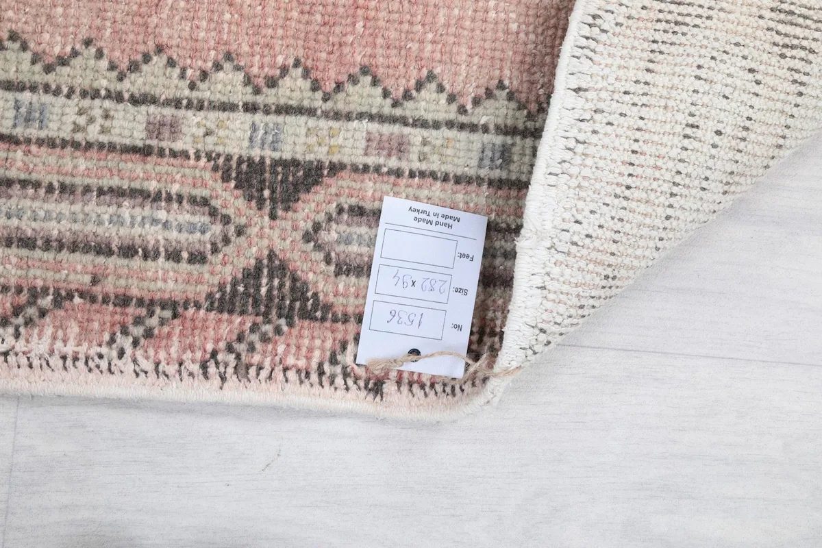 Close-up of the rug's edge and a small tag indicating its origin and material