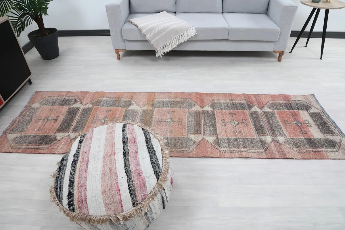 Full room shot of the runner, gray sofa, and decorative elements