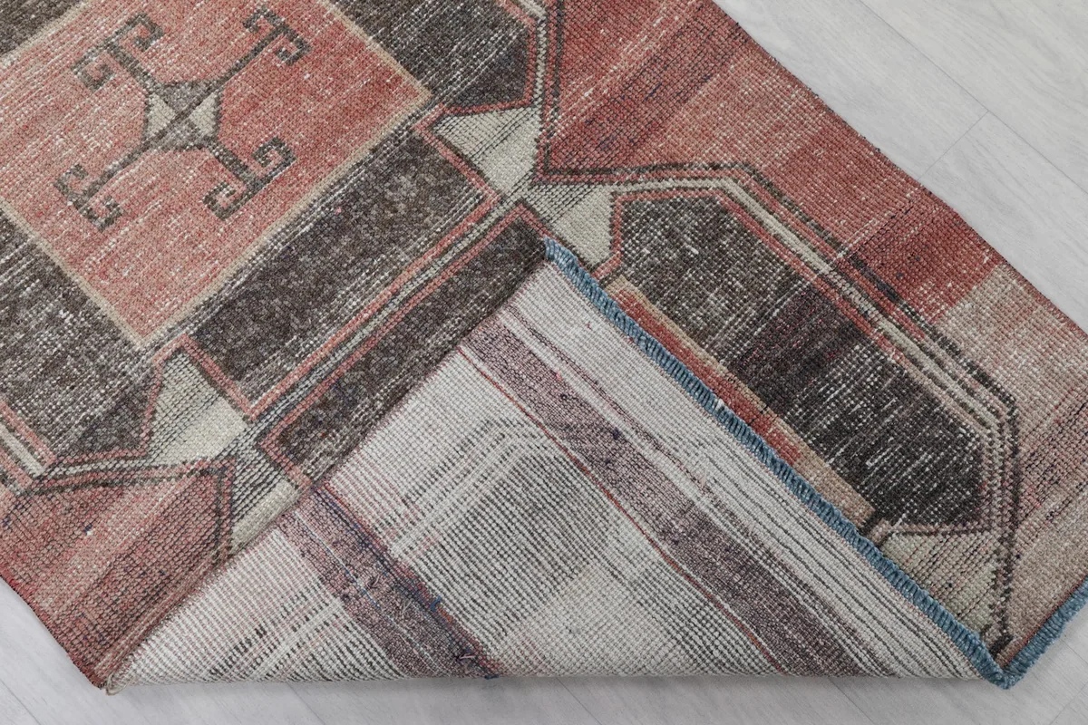Underside of the rug, showing the cotton foundation and hand-knotted construction