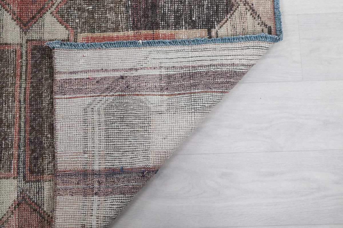 Close-up of the rug's back, revealing the tight knotting and foundation