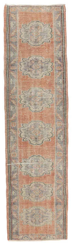 Full top view of the 2'7" x 9'8" rust and gray medallion vintage Anatolian runner rug.