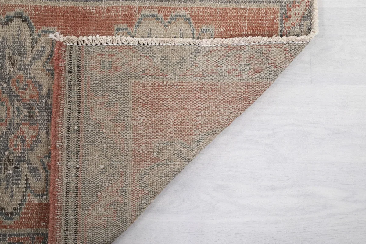 Underside view of the rug, showing the tightly woven cotton foundation and craftsmanship.
