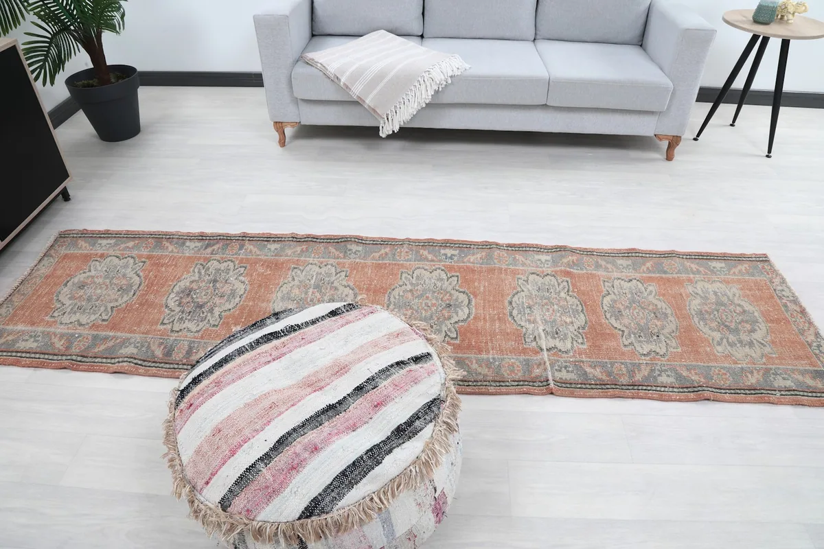 Overhead view of the vintage runner rug in a room setting, capturing its full design.