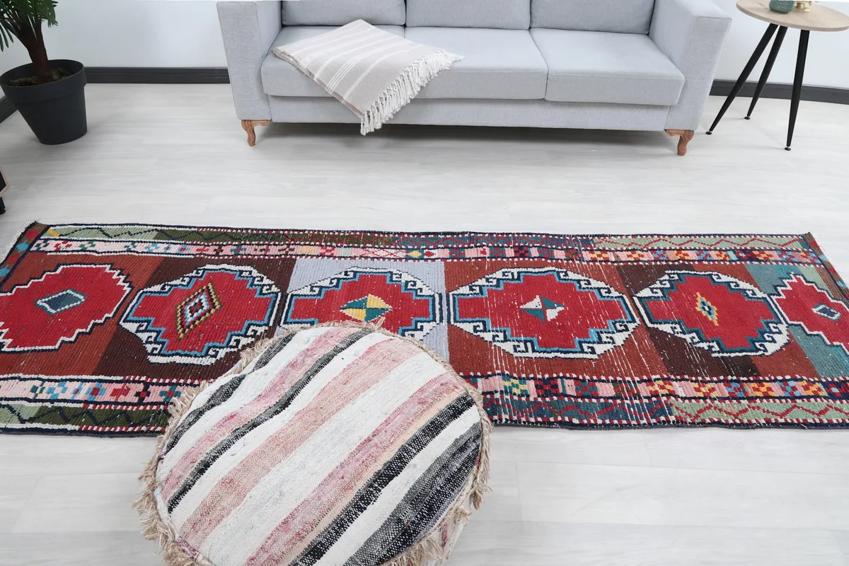 Overhead view of the runner rug in the room, showing its full length and the repeating geometric motifs.