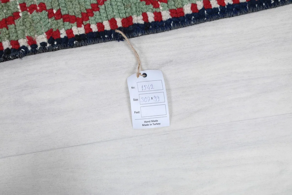White tag attached to the rug, displaying product information and origin details on a light floor.