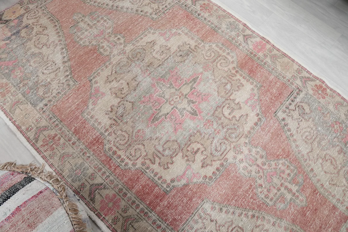 Overhead angled view highlighting the central medallion and surrounding patterns of the rug