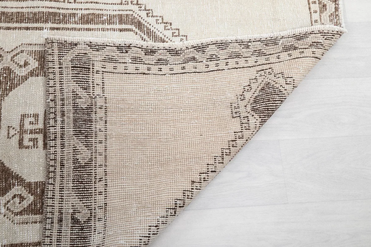 Close-up of the back of the rug, revealing the hand-knotted construction and cotton foundation.