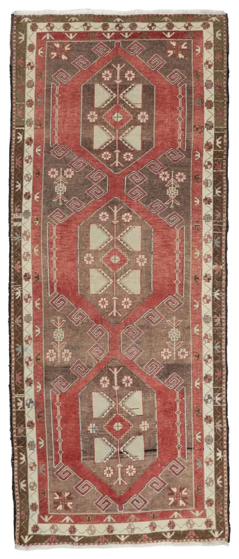 Full overhead view of the vintage Anatolian runner rug with red, brown, and beige geometric patterns