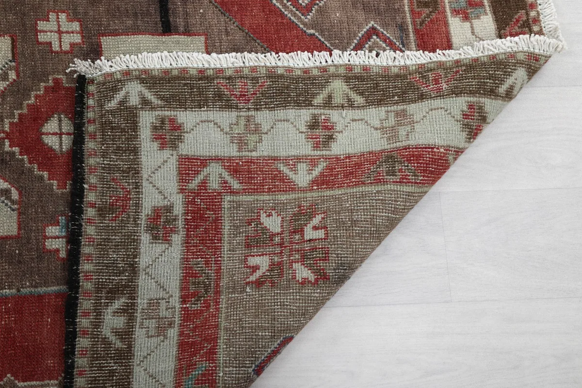 Close-up of the rug's reverse side and fringe, showing the intricate hand-knotted construction