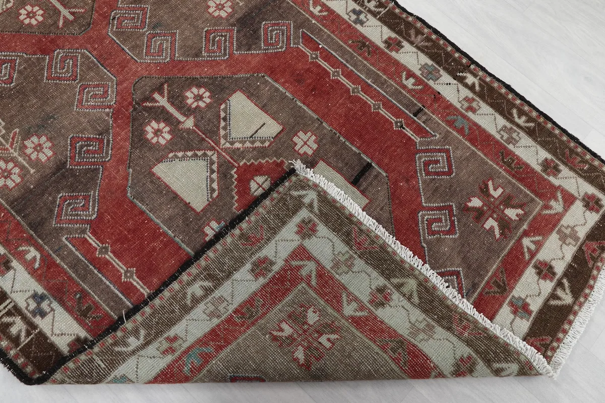 Folded corner of the runner rug, revealing the reverse side of the hand-knotted cotton foundation