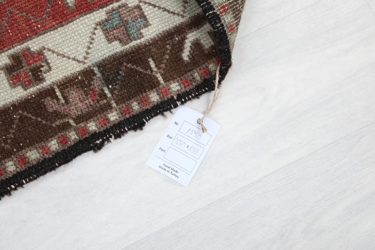 Detail of the rug's edge with a product tag, indicating its origin and material