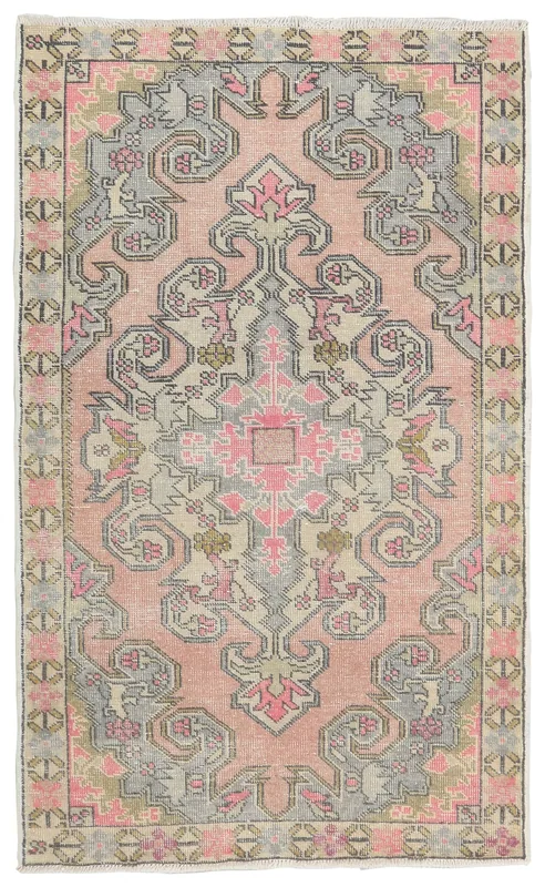 Full overhead view of a vintage hand-knotted pink and gray Anatolian wool rug.
